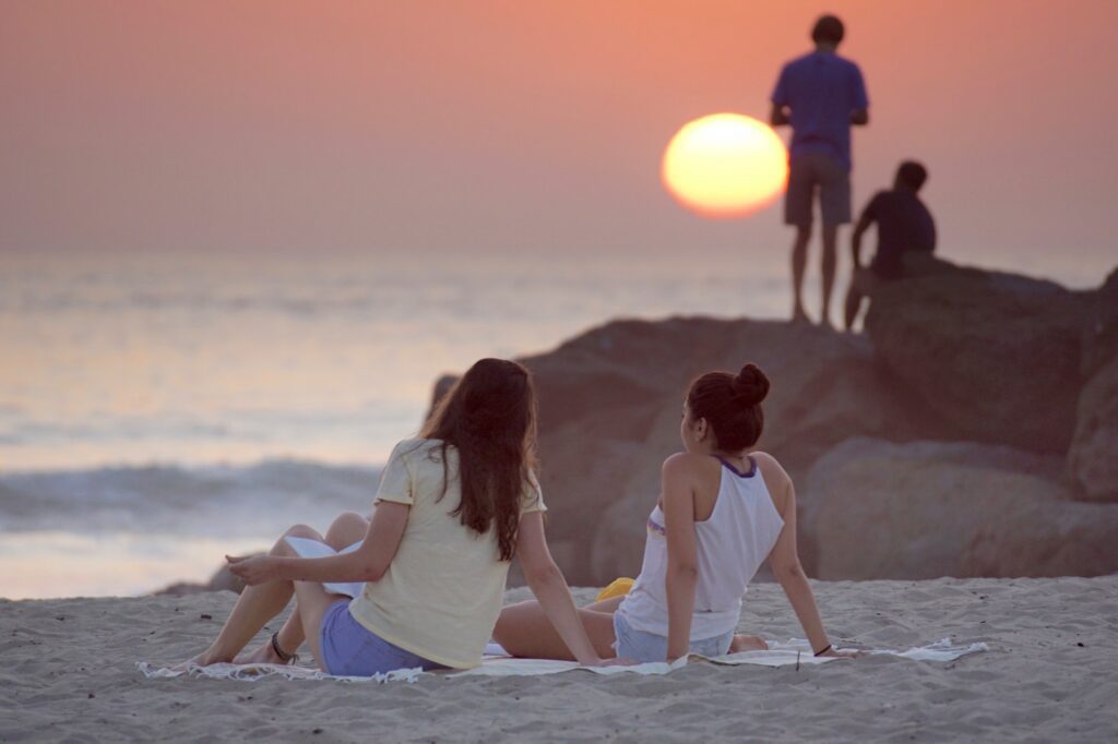 Candid people at the beach during sunset
