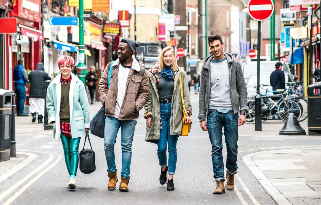 Multicultural students walking on Brick Lane center at Shoreditch London